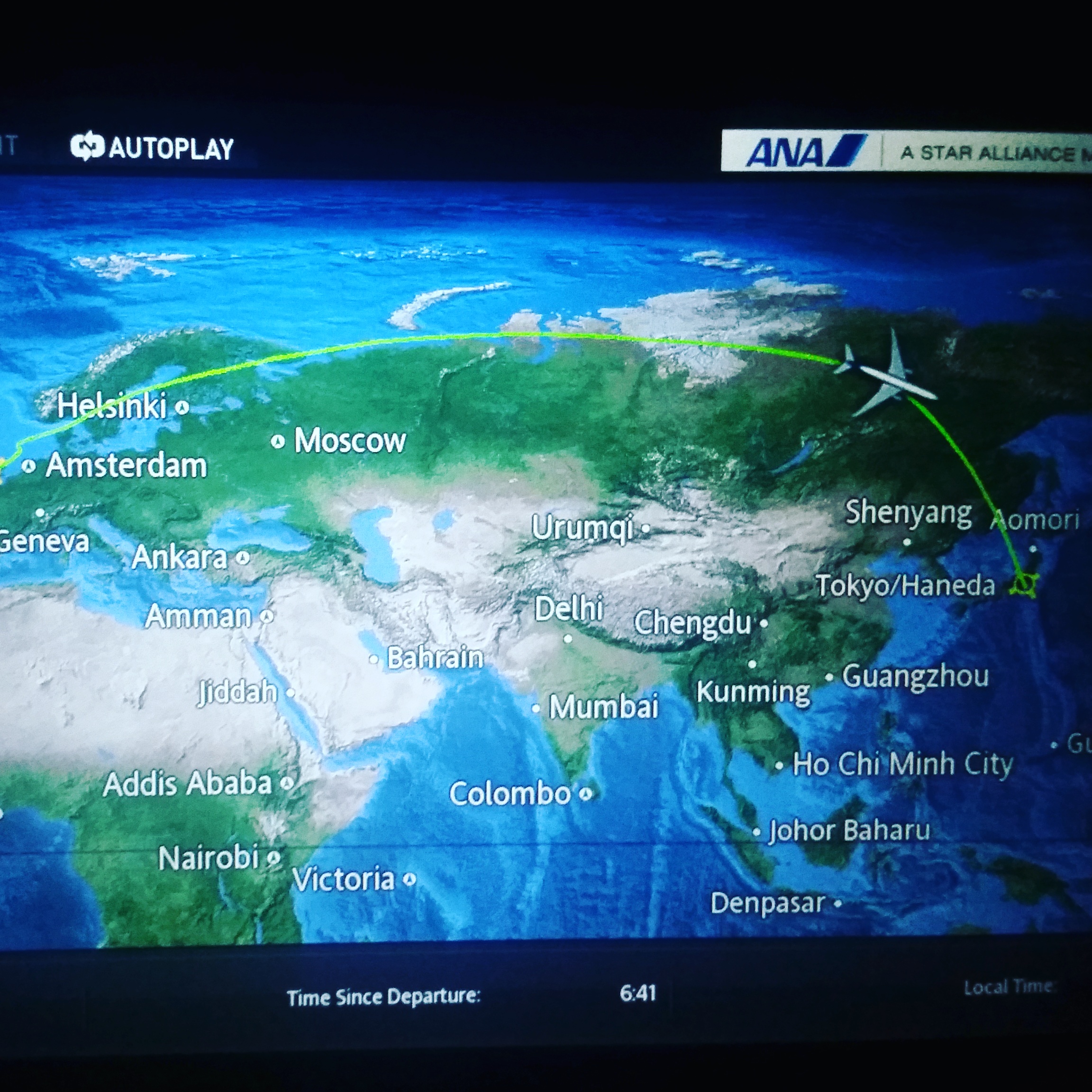 TV screen on airplane showing map with route from Heathrow to Tokyo