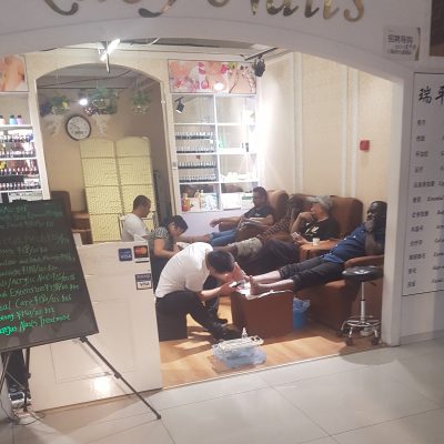Lots of men pampering themselves in a nail bar!